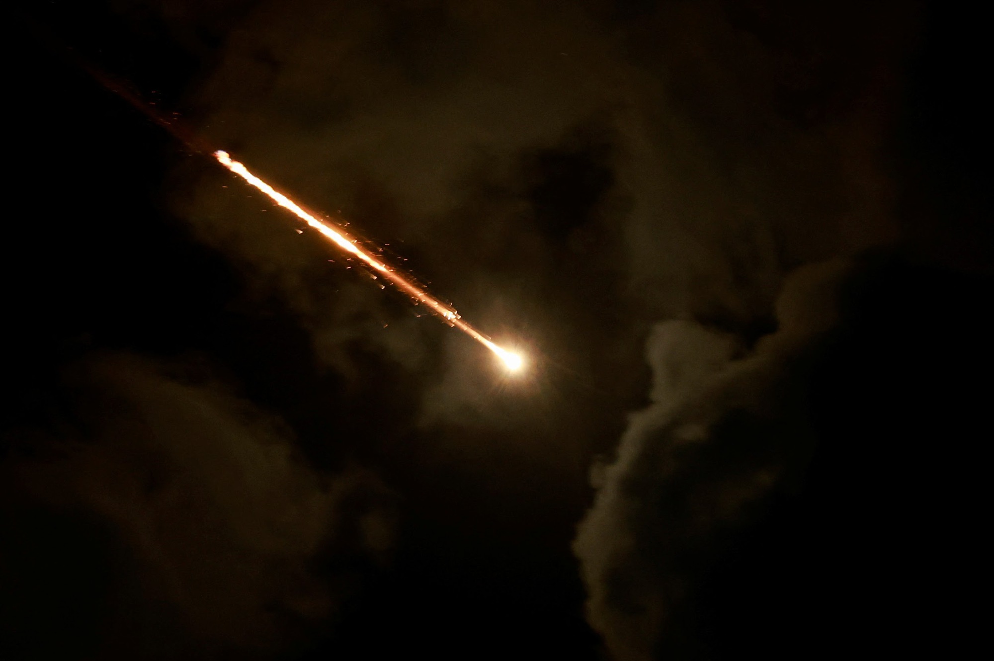 A projectile is seen in the sky after Iran fired a salvo of ballistic missiles, amid cross-border hostilities between Hezbollah and Israel, as seen from Tel Aviv