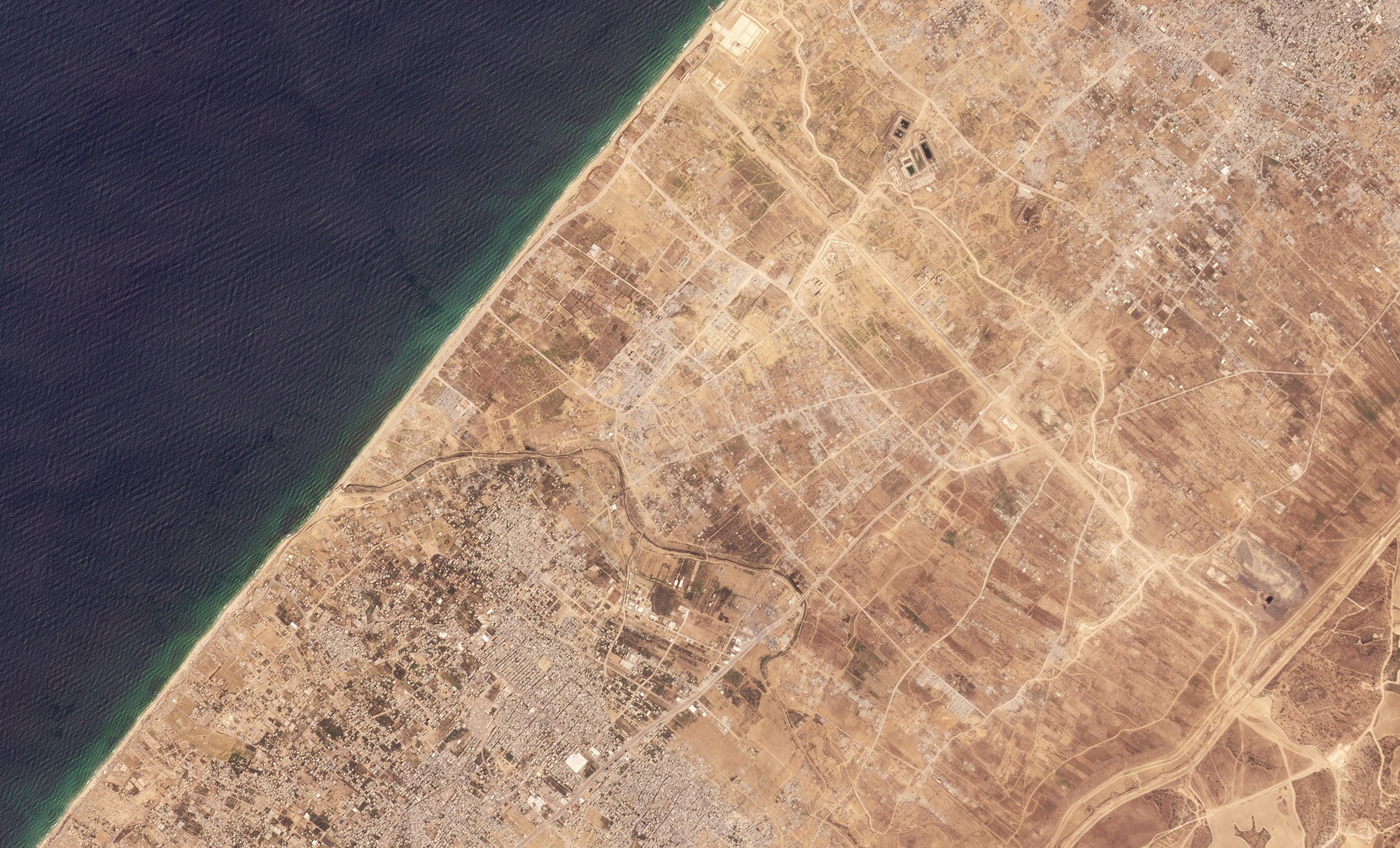 A satellite image shows the Netzarim Corridor, an area of central Gaza cleared by the Israeli military after invading the Palestinian enclave, August 20, 2024. Troops deployed along the corridor prevent the free movement of Gazans between the north and south of the enclave. via Planet Labs Inc.