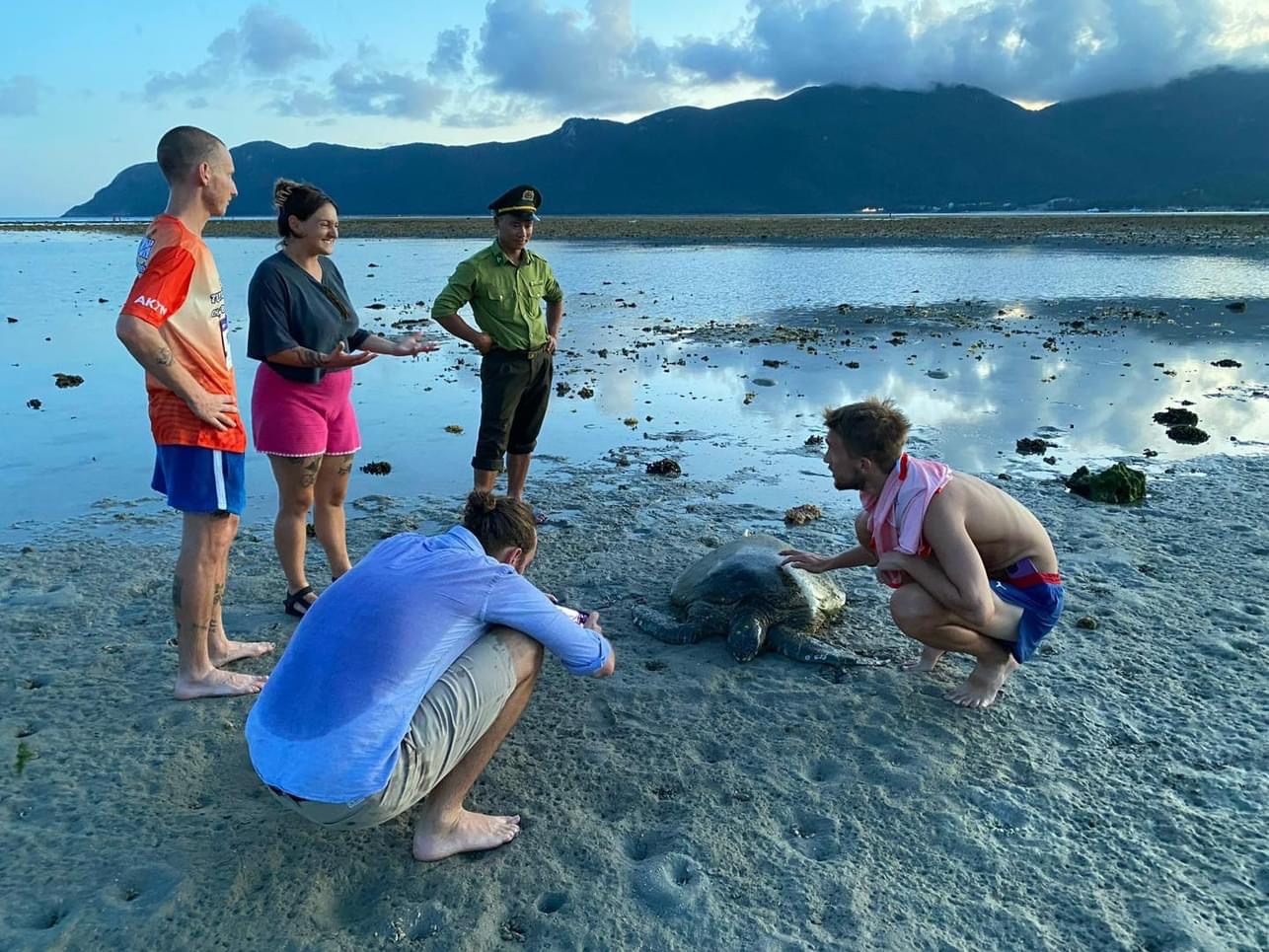 A group of people on a beach  Description automatically generated