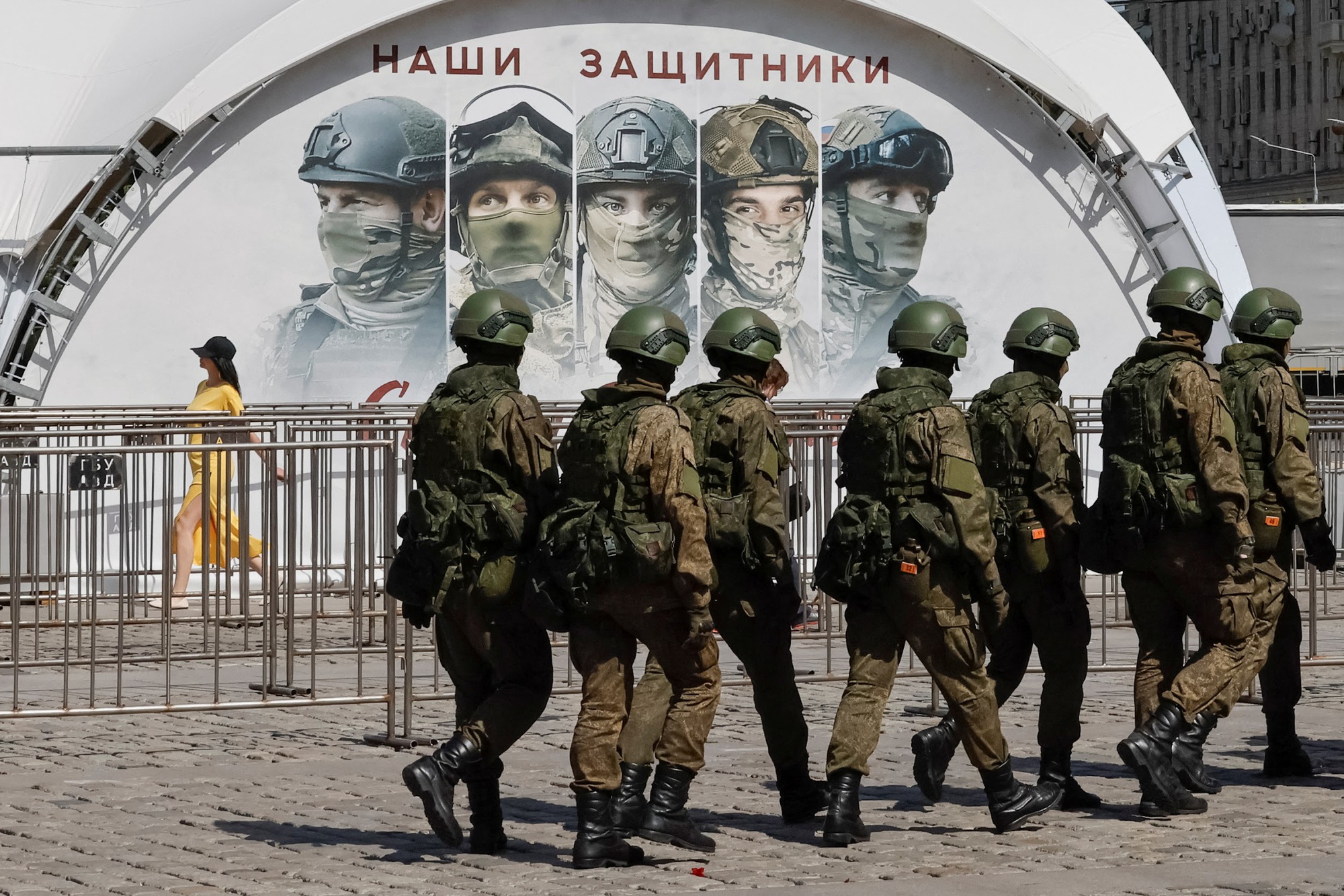 Russian army servicemen walk at an exhibition displaying armoured vehicles and equipment captured by the Russian army from Ukrainian forces