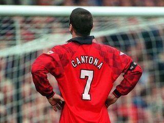 Một bức ảnh chụp từ phía sau của Eric Cantona của Manchester United đang đứng với hai tay chống nạnh, năm 1997