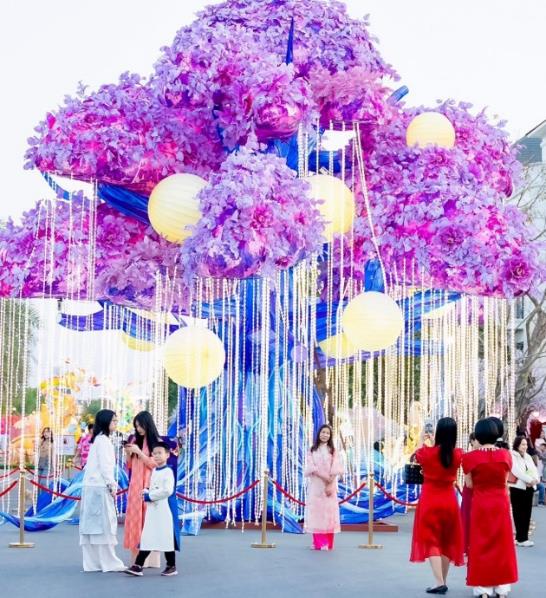 A group of people standing under a purple tree  AI-generated content may be incorrect.