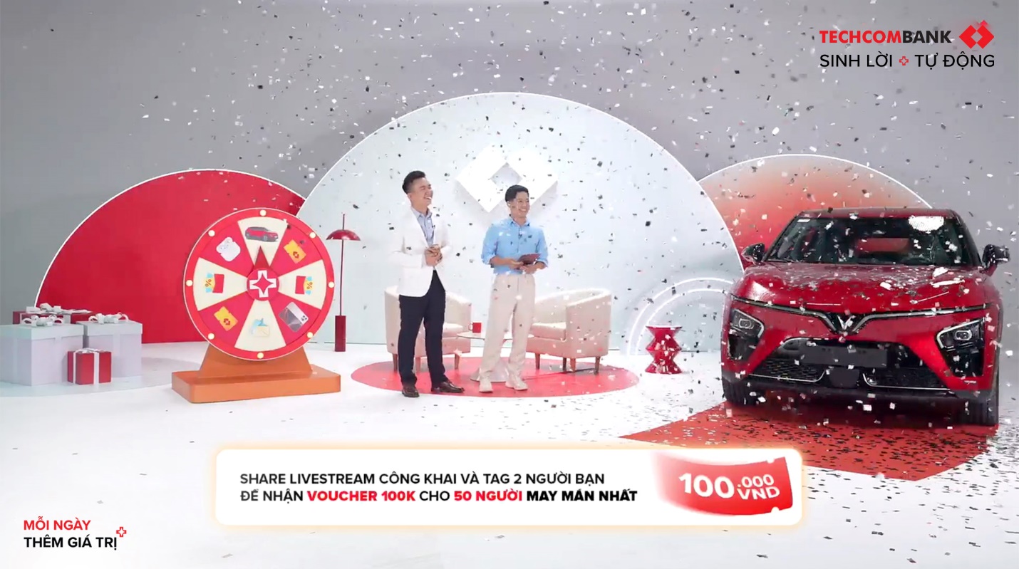 Lộ diện chủ nhân ô tô VinFast - Giải thưởng khủng từ “Sinh Lời Trúng Lớn” cùng Techcombank- Ảnh 1. A couple of men standing in front of a red car Description automatically generated