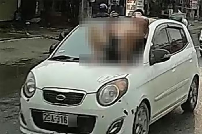 Khởi tố bố vợ và con rể trong vụ nằm trên nắp capo ô tô đang chạy ở Hà Nội - Ảnh 1.