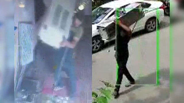 Người đàn ông trộm cây nước rồi vác trên vai đi bộ trên phố - Ảnh 1.