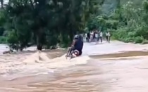 Cố băng qua cầu ngập nước, 3 người đi xe máy bị nước cuốn trôi