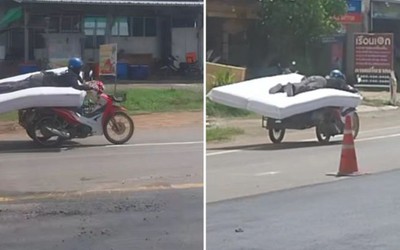 Thót tim cảnh người đàn ông lái xe máy trong khi nằm trên nệm