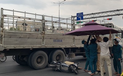 CSGT căng dù che mưa cho thi thể cô gái bị xe tải cán tử vong